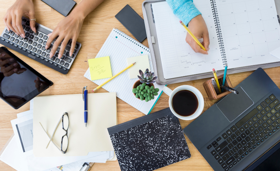 Two people working on scheduling in an office.